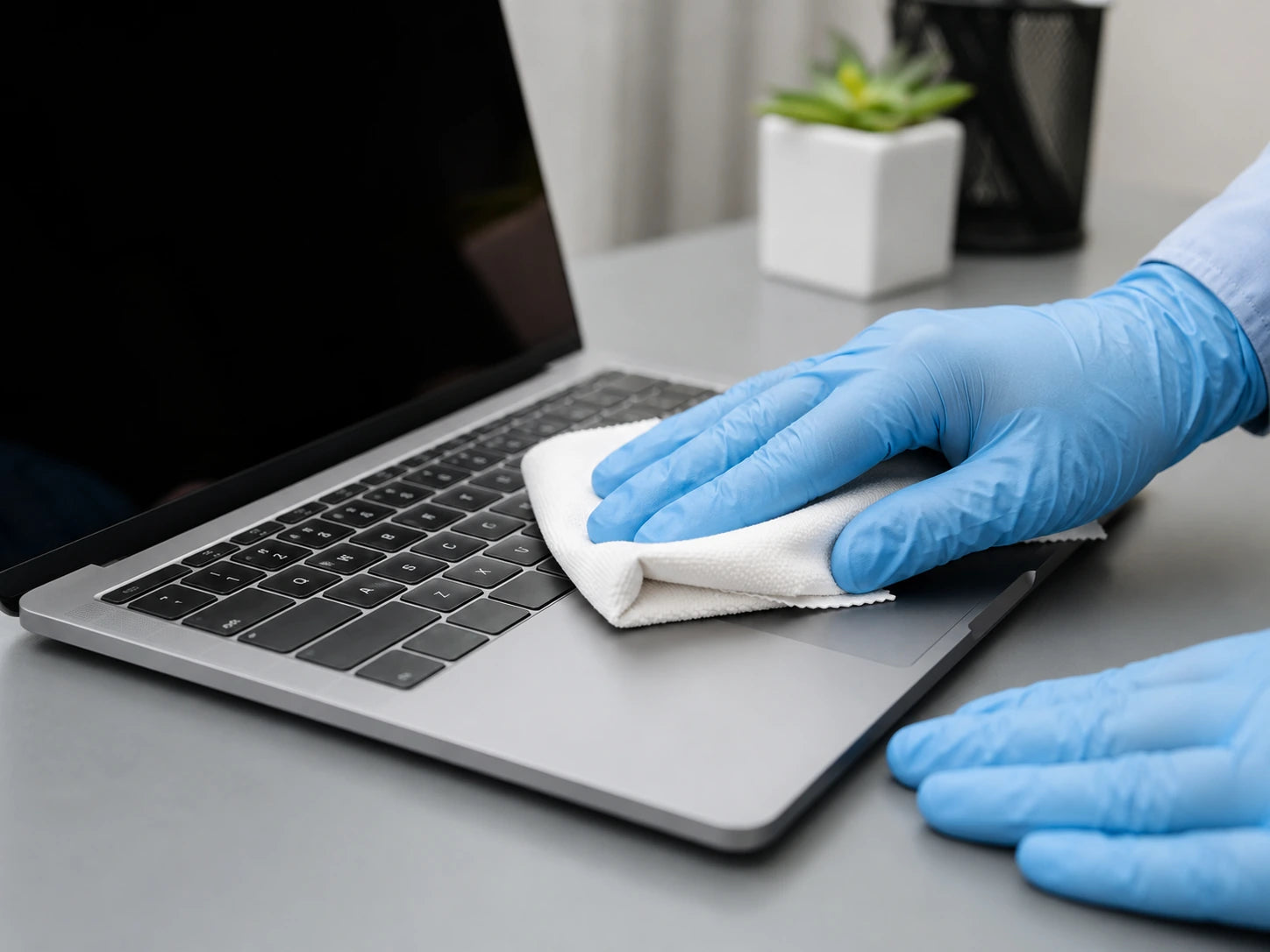 Laptop being cleaned and sanitised before rental